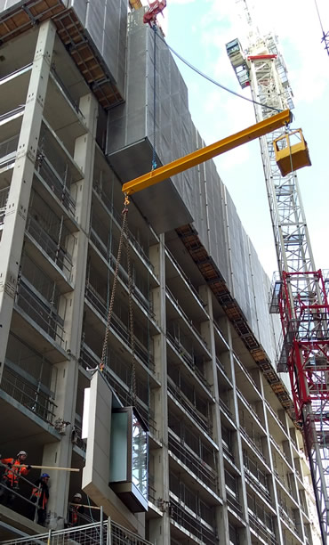 Counter Balance Lifting Beam designed to lift wall panels shown positioning a unit under a scaffold overhang.